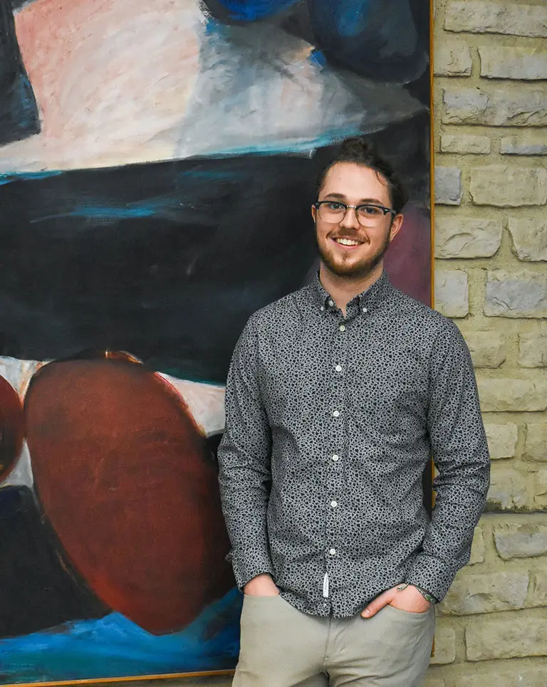 a man standing in front of a painting