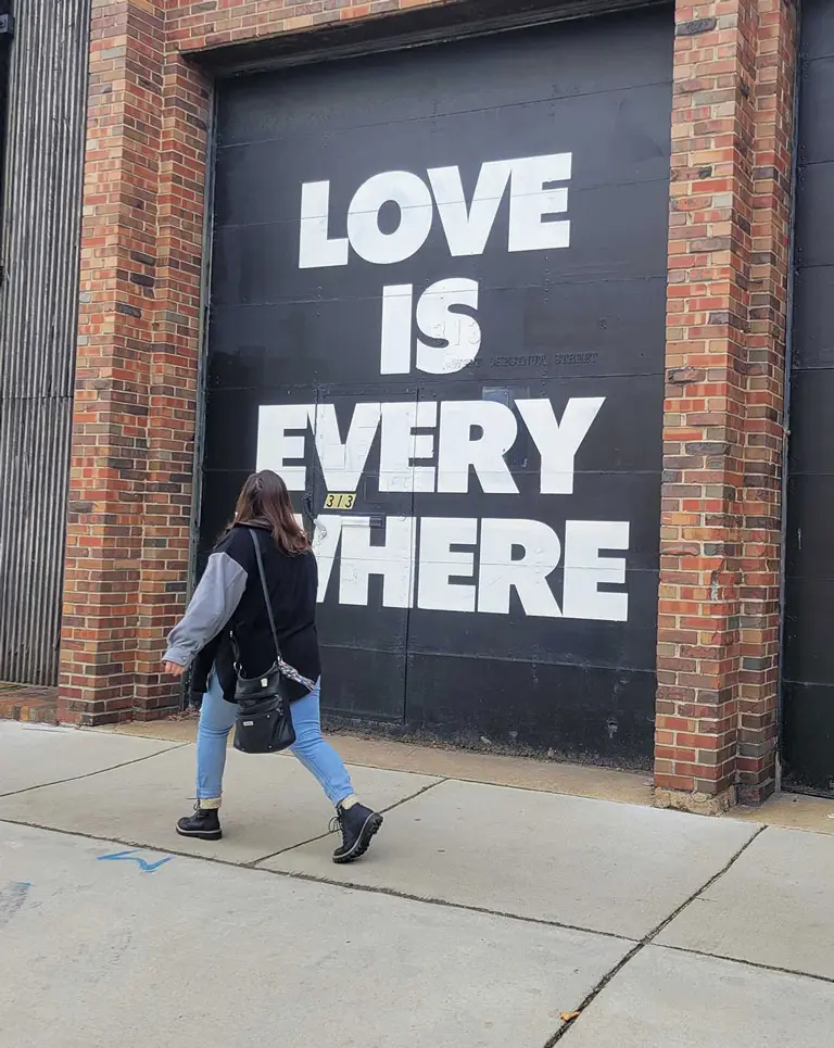 a woman walking on a sidewalk