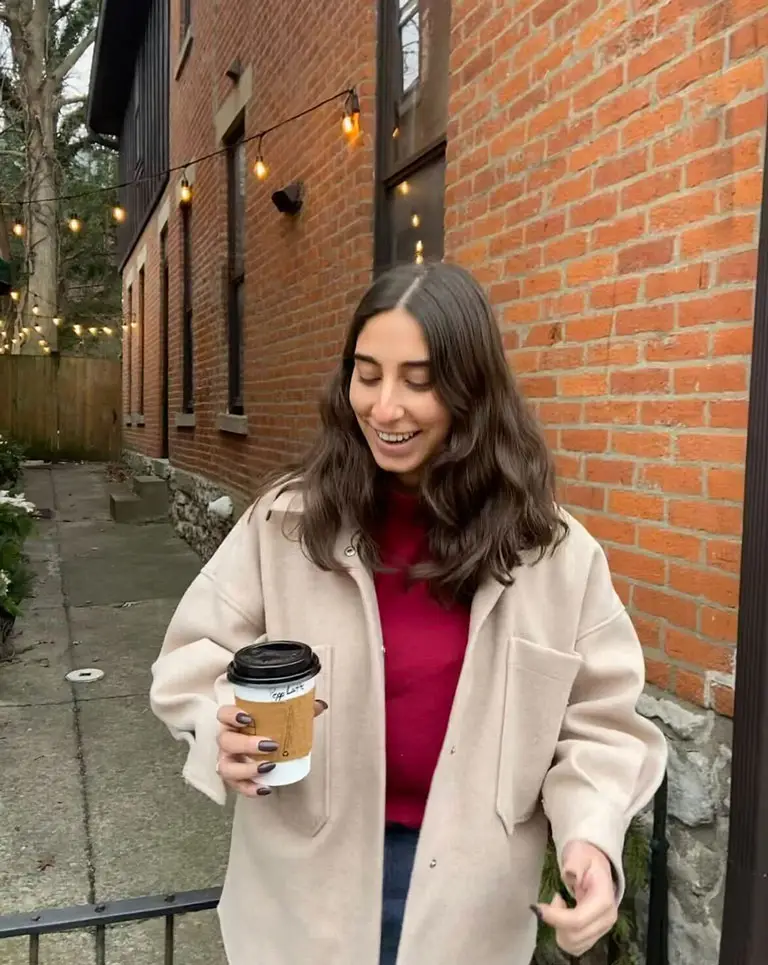 a woman holding a coffee cup