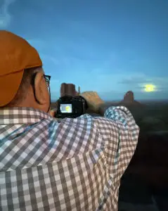 a man taking a picture of a desert