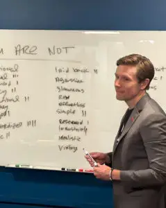 a man standing in front of a whiteboard