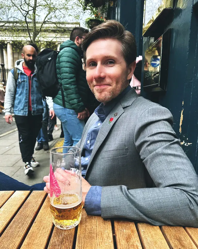 a man sitting at a table with a drink