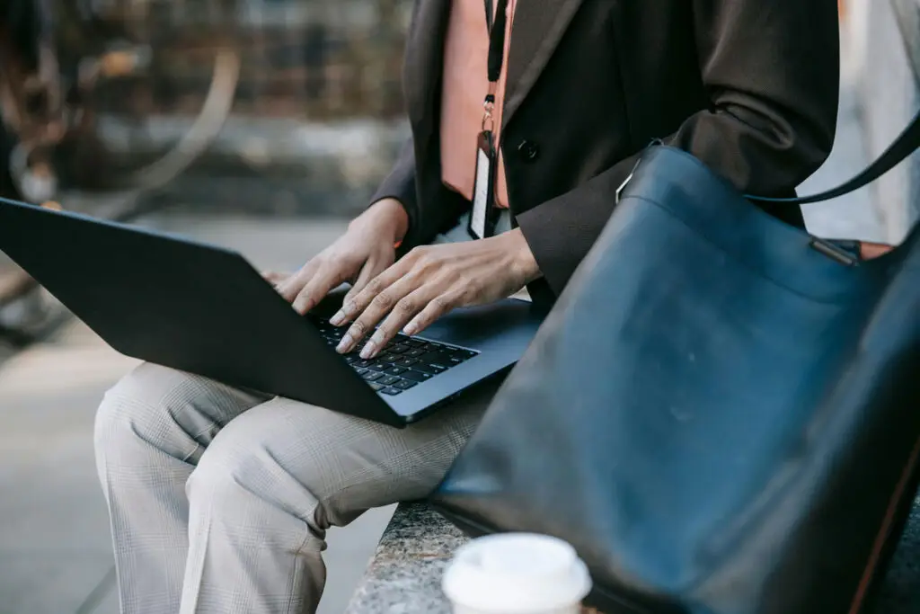 hands typing on laptop outside searching for SEO for Law Firms